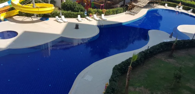 <p><strong>Project Name:Liparsi Sunset (Arpa&ccedil;bahşiş)</strong></p>

<p><strong>Our project, which is established on 7.956.91 M2 Green area, consists of 2 blocks and 196 apartments.&nbsp;Our project has 16 floors and there are 6-8 apartments on each floor.</strong></p>

<p><strong>Outdoor Features</strong></p>

<p><strong>∙&nbsp;&nbsp;&nbsp;&nbsp;&nbsp;&nbsp;&nbsp;&nbsp;Central Satellite</strong></p>

<p><strong>∙&nbsp;&nbsp;&nbsp;&nbsp;&nbsp;&nbsp;&nbsp;&nbsp;Central Solar Water Heater</strong></p>

<p><strong>∙&nbsp;&nbsp;&nbsp;&nbsp;&nbsp;&nbsp;&nbsp;&nbsp;Fully Equipped Generator</strong></p>

<p><strong>∙&nbsp;&nbsp;&nbsp;&nbsp;&nbsp;&nbsp;&nbsp;&nbsp;Outdoor Car Park</strong></p>

<p><strong>∙&nbsp;&nbsp;&nbsp;&nbsp;&nbsp;&nbsp;&nbsp;&nbsp;Photocell Building Entrance</strong></p>

<p><strong>∙&nbsp;&nbsp;&nbsp;&nbsp;&nbsp;&nbsp;&nbsp;&nbsp;Full Automatic 2 Elevators</strong></p>

<p><strong>Interior Features</strong></p>

<p><strong>∙&nbsp;&nbsp;&nbsp;&nbsp;&nbsp;&nbsp;&nbsp;&nbsp;Apartments 1+1 - 73/75 M2 / 2+1-95/105 M2</strong></p>

<p><strong>∙&nbsp;&nbsp;&nbsp;&nbsp;&nbsp;&nbsp;&nbsp;&nbsp;Air Conditioning Installation Collection Area</strong></p>

<p><strong>∙&nbsp;&nbsp;&nbsp;&nbsp;&nbsp;&nbsp;&nbsp;&nbsp;Entrance Door Steel Door</strong></p>

<p><strong>∙&nbsp;&nbsp;&nbsp;&nbsp;&nbsp;&nbsp;&nbsp;&nbsp;Special Design Cloakroom</strong></p>

<p><strong>∙&nbsp;&nbsp;&nbsp;&nbsp;&nbsp;&nbsp;&nbsp;&nbsp;Special Design Interior Doors</strong></p>

<p><strong>∙&nbsp;&nbsp;&nbsp;&nbsp;&nbsp;&nbsp;&nbsp;&nbsp;Wet Floors 1st Class Ceramic and Granite</strong></p>

<p><strong>∙&nbsp;&nbsp;&nbsp;&nbsp;&nbsp;&nbsp;&nbsp;&nbsp;Pvc Joinery (Double Glass-Insulating Glass)</strong></p>

<p><strong>∙&nbsp;&nbsp;&nbsp;&nbsp;&nbsp;&nbsp;&nbsp;&nbsp;Interior Doors Special Design</strong></p>

<p><strong>∙&nbsp;&nbsp;&nbsp;&nbsp;&nbsp;&nbsp;&nbsp;&nbsp;Space-Appropriate MDF Kitchen Cabinets</strong></p>

<p><strong>∙&nbsp;&nbsp;&nbsp;&nbsp;&nbsp;&nbsp;&nbsp;&nbsp;Granite Countertops</strong></p>

<p><strong>∙&nbsp;&nbsp;&nbsp;&nbsp;&nbsp;&nbsp;&nbsp;&nbsp;Custom Design Laundry Cabinet</strong></p>

<p><strong>∙&nbsp;&nbsp;&nbsp;&nbsp;&nbsp;&nbsp;&nbsp;&nbsp;2 Pcs Special Design Bathroom Cabinet</strong></p>

<p><strong>∙&nbsp;&nbsp;&nbsp;&nbsp;&nbsp;&nbsp;&nbsp;&nbsp;General Wc General Bathroom And En-Suite Bathroom</strong></p>

<p><strong>∙&nbsp;&nbsp;&nbsp;&nbsp;&nbsp;&nbsp;&nbsp;&nbsp;Shower</strong></p>

<p><strong>∙&nbsp;&nbsp;&nbsp;&nbsp;&nbsp;&nbsp;&nbsp;&nbsp;Chrome Balcony Railings Glass Plated Square Handrail</strong></p>

<p><strong>Social Areas</strong></p>

<p><strong>∙&nbsp;&nbsp;&nbsp;&nbsp;&nbsp;&nbsp;&nbsp;&nbsp;Outdoor Fitness</strong></p>

<p><strong>∙&nbsp;&nbsp;&nbsp;&nbsp;&nbsp;&nbsp;&nbsp;&nbsp;Outdoor Pool</strong></p>

<p><strong>∙&nbsp;&nbsp;&nbsp;&nbsp;&nbsp;&nbsp;&nbsp;&nbsp;Aqua Park</strong></p>

<p><strong>∙&nbsp;&nbsp;&nbsp;&nbsp;&nbsp;&nbsp;&nbsp;&nbsp;Camellias</strong></p>

<p><strong>∙&nbsp;&nbsp;&nbsp;&nbsp;&nbsp;&nbsp;&nbsp;&nbsp;BBQ Areas</strong></p>

<p><strong>∙&nbsp;&nbsp;&nbsp;&nbsp;&nbsp;&nbsp;&nbsp;&nbsp;Children's Playground</strong></p>

<p><strong>∙&nbsp;&nbsp;&nbsp;&nbsp;&nbsp;&nbsp;&nbsp;&nbsp;Jogging Paths</strong></p>

<p><strong>Security Features</strong></p>

<p><strong>∙&nbsp;&nbsp;&nbsp;&nbsp;&nbsp;&nbsp;&nbsp;&nbsp;Earthquake Regulation</strong></p>

<p><strong>∙&nbsp;&nbsp;&nbsp;&nbsp;&nbsp;&nbsp;&nbsp;&nbsp;7/24 Private Security</strong></p>

<p><strong>∙&nbsp;&nbsp;&nbsp;&nbsp;&nbsp;&nbsp;&nbsp;&nbsp;Fotoselli Site Entrance Gate</strong></p>

<p><strong>∙&nbsp;&nbsp;&nbsp;&nbsp;&nbsp;&nbsp;&nbsp;&nbsp;Bored pile</strong></p>

<p><strong>∙&nbsp;&nbsp;&nbsp;&nbsp;&nbsp;&nbsp;&nbsp;&nbsp;Fire Escapes</strong></p>

<p><strong>∙&nbsp;&nbsp;&nbsp;&nbsp;&nbsp;&nbsp;&nbsp;&nbsp;Central Camera System</strong></p>

<p><br />
&nbsp;</p>
