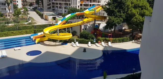 <p><strong>Project Name:Liparsi Sunset (Arpa&ccedil;bahşiş)</strong></p>

<p><strong>Our project, which is established on 7.956.91 M2 Green area, consists of 2 blocks and 196 apartments.&nbsp;Our project has 16 floors and there are 6-8 apartments on each floor.</strong></p>

<p><strong>Outdoor Features</strong></p>

<p><strong>∙&nbsp;&nbsp;&nbsp;&nbsp;&nbsp;&nbsp;&nbsp;&nbsp;Central Satellite</strong></p>

<p><strong>∙&nbsp;&nbsp;&nbsp;&nbsp;&nbsp;&nbsp;&nbsp;&nbsp;Central Solar Water Heater</strong></p>

<p><strong>∙&nbsp;&nbsp;&nbsp;&nbsp;&nbsp;&nbsp;&nbsp;&nbsp;Fully Equipped Generator</strong></p>

<p><strong>∙&nbsp;&nbsp;&nbsp;&nbsp;&nbsp;&nbsp;&nbsp;&nbsp;Outdoor Car Park</strong></p>

<p><strong>∙&nbsp;&nbsp;&nbsp;&nbsp;&nbsp;&nbsp;&nbsp;&nbsp;Photocell Building Entrance</strong></p>

<p><strong>∙&nbsp;&nbsp;&nbsp;&nbsp;&nbsp;&nbsp;&nbsp;&nbsp;Full Automatic 2 Elevators</strong></p>

<p><strong>Interior Features</strong></p>

<p><strong>∙&nbsp;&nbsp;&nbsp;&nbsp;&nbsp;&nbsp;&nbsp;&nbsp;Apartments 1+1 - 73/75 M2 / 2+1-95/105 M2</strong></p>

<p><strong>∙&nbsp;&nbsp;&nbsp;&nbsp;&nbsp;&nbsp;&nbsp;&nbsp;Air Conditioning Installation Collection Area</strong></p>

<p><strong>∙&nbsp;&nbsp;&nbsp;&nbsp;&nbsp;&nbsp;&nbsp;&nbsp;Entrance Door Steel Door</strong></p>

<p><strong>∙&nbsp;&nbsp;&nbsp;&nbsp;&nbsp;&nbsp;&nbsp;&nbsp;Special Design Cloakroom</strong></p>

<p><strong>∙&nbsp;&nbsp;&nbsp;&nbsp;&nbsp;&nbsp;&nbsp;&nbsp;Special Design Interior Doors</strong></p>

<p><strong>∙&nbsp;&nbsp;&nbsp;&nbsp;&nbsp;&nbsp;&nbsp;&nbsp;Wet Floors 1st Class Ceramic and Granite</strong></p>

<p><strong>∙&nbsp;&nbsp;&nbsp;&nbsp;&nbsp;&nbsp;&nbsp;&nbsp;Pvc Joinery (Double Glass-Insulating Glass)</strong></p>

<p><strong>∙&nbsp;&nbsp;&nbsp;&nbsp;&nbsp;&nbsp;&nbsp;&nbsp;Interior Doors Special Design</strong></p>

<p><strong>∙&nbsp;&nbsp;&nbsp;&nbsp;&nbsp;&nbsp;&nbsp;&nbsp;Space-Appropriate MDF Kitchen Cabinets</strong></p>

<p><strong>∙&nbsp;&nbsp;&nbsp;&nbsp;&nbsp;&nbsp;&nbsp;&nbsp;Granite Countertops</strong></p>

<p><strong>∙&nbsp;&nbsp;&nbsp;&nbsp;&nbsp;&nbsp;&nbsp;&nbsp;Custom Design Laundry Cabinet</strong></p>

<p><strong>∙&nbsp;&nbsp;&nbsp;&nbsp;&nbsp;&nbsp;&nbsp;&nbsp;2 Pcs Special Design Bathroom Cabinet</strong></p>

<p><strong>∙&nbsp;&nbsp;&nbsp;&nbsp;&nbsp;&nbsp;&nbsp;&nbsp;General Wc General Bathroom And En-Suite Bathroom</strong></p>

<p><strong>∙&nbsp;&nbsp;&nbsp;&nbsp;&nbsp;&nbsp;&nbsp;&nbsp;Shower</strong></p>

<p><strong>∙&nbsp;&nbsp;&nbsp;&nbsp;&nbsp;&nbsp;&nbsp;&nbsp;Chrome Balcony Railings Glass Plated Square Handrail</strong></p>

<p><strong>Social Areas</strong></p>

<p><strong>∙&nbsp;&nbsp;&nbsp;&nbsp;&nbsp;&nbsp;&nbsp;&nbsp;Outdoor Fitness</strong></p>

<p><strong>∙&nbsp;&nbsp;&nbsp;&nbsp;&nbsp;&nbsp;&nbsp;&nbsp;Outdoor Pool</strong></p>

<p><strong>∙&nbsp;&nbsp;&nbsp;&nbsp;&nbsp;&nbsp;&nbsp;&nbsp;Aqua Park</strong></p>

<p><strong>∙&nbsp;&nbsp;&nbsp;&nbsp;&nbsp;&nbsp;&nbsp;&nbsp;Camellias</strong></p>

<p><strong>∙&nbsp;&nbsp;&nbsp;&nbsp;&nbsp;&nbsp;&nbsp;&nbsp;BBQ Areas</strong></p>

<p><strong>∙&nbsp;&nbsp;&nbsp;&nbsp;&nbsp;&nbsp;&nbsp;&nbsp;Children's Playground</strong></p>

<p><strong>∙&nbsp;&nbsp;&nbsp;&nbsp;&nbsp;&nbsp;&nbsp;&nbsp;Jogging Paths</strong></p>

<p><strong>Security Features</strong></p>

<p><strong>∙&nbsp;&nbsp;&nbsp;&nbsp;&nbsp;&nbsp;&nbsp;&nbsp;Earthquake Regulation</strong></p>

<p><strong>∙&nbsp;&nbsp;&nbsp;&nbsp;&nbsp;&nbsp;&nbsp;&nbsp;7/24 Private Security</strong></p>

<p><strong>∙&nbsp;&nbsp;&nbsp;&nbsp;&nbsp;&nbsp;&nbsp;&nbsp;Fotoselli Site Entrance Gate</strong></p>

<p><strong>∙&nbsp;&nbsp;&nbsp;&nbsp;&nbsp;&nbsp;&nbsp;&nbsp;Bored pile</strong></p>

<p><strong>∙&nbsp;&nbsp;&nbsp;&nbsp;&nbsp;&nbsp;&nbsp;&nbsp;Fire Escapes</strong></p>

<p><strong>∙&nbsp;&nbsp;&nbsp;&nbsp;&nbsp;&nbsp;&nbsp;&nbsp;Central Camera System</strong></p>

<p><br />
&nbsp;</p>
